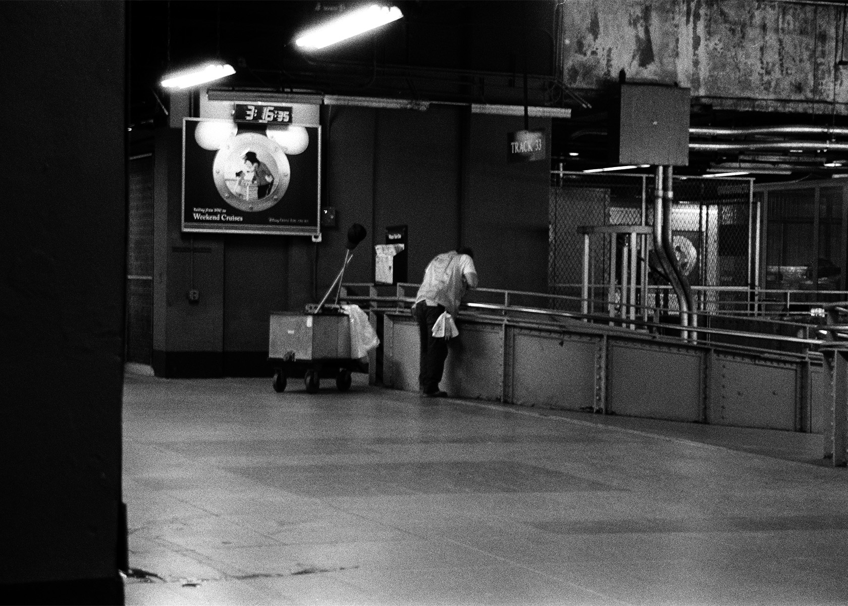 custodian onlooking on the train platform