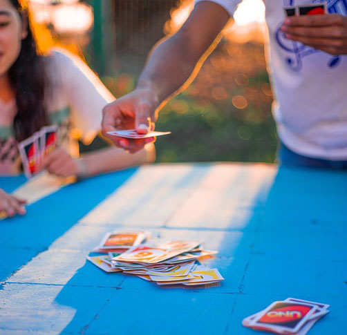 People playing Uno, a board game