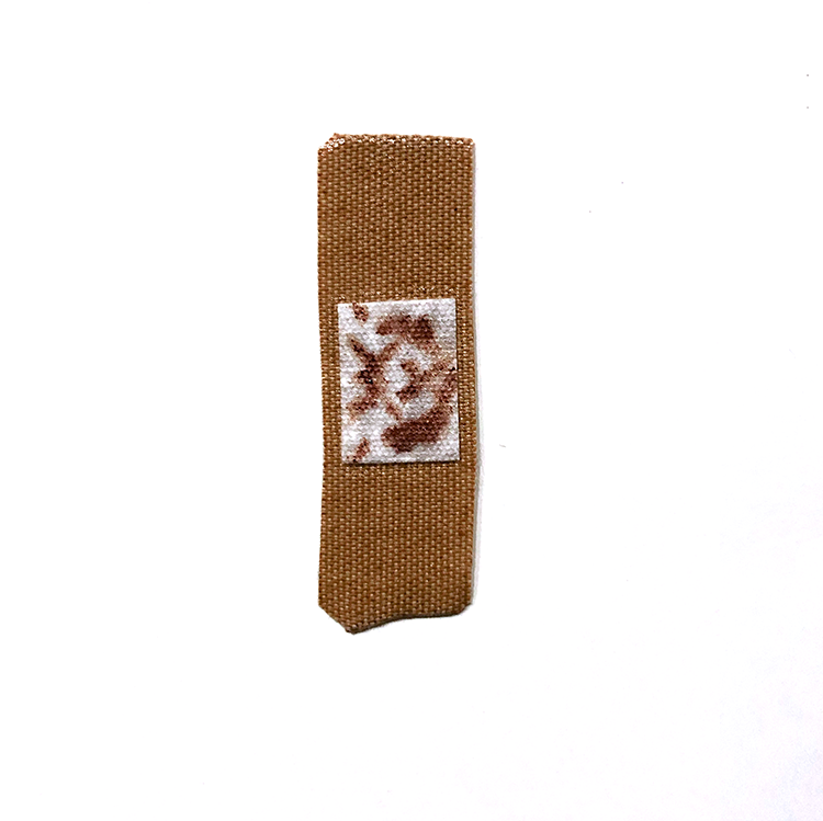 a band aid with a blood stain in the shape of a rorschach test.
