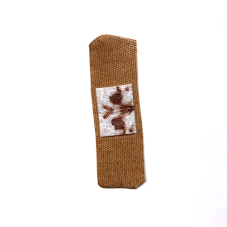 a band aid with a blood stain in the shape of a rorschach test.