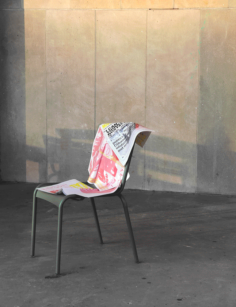 A copy of the newspaper draped on a green chair.