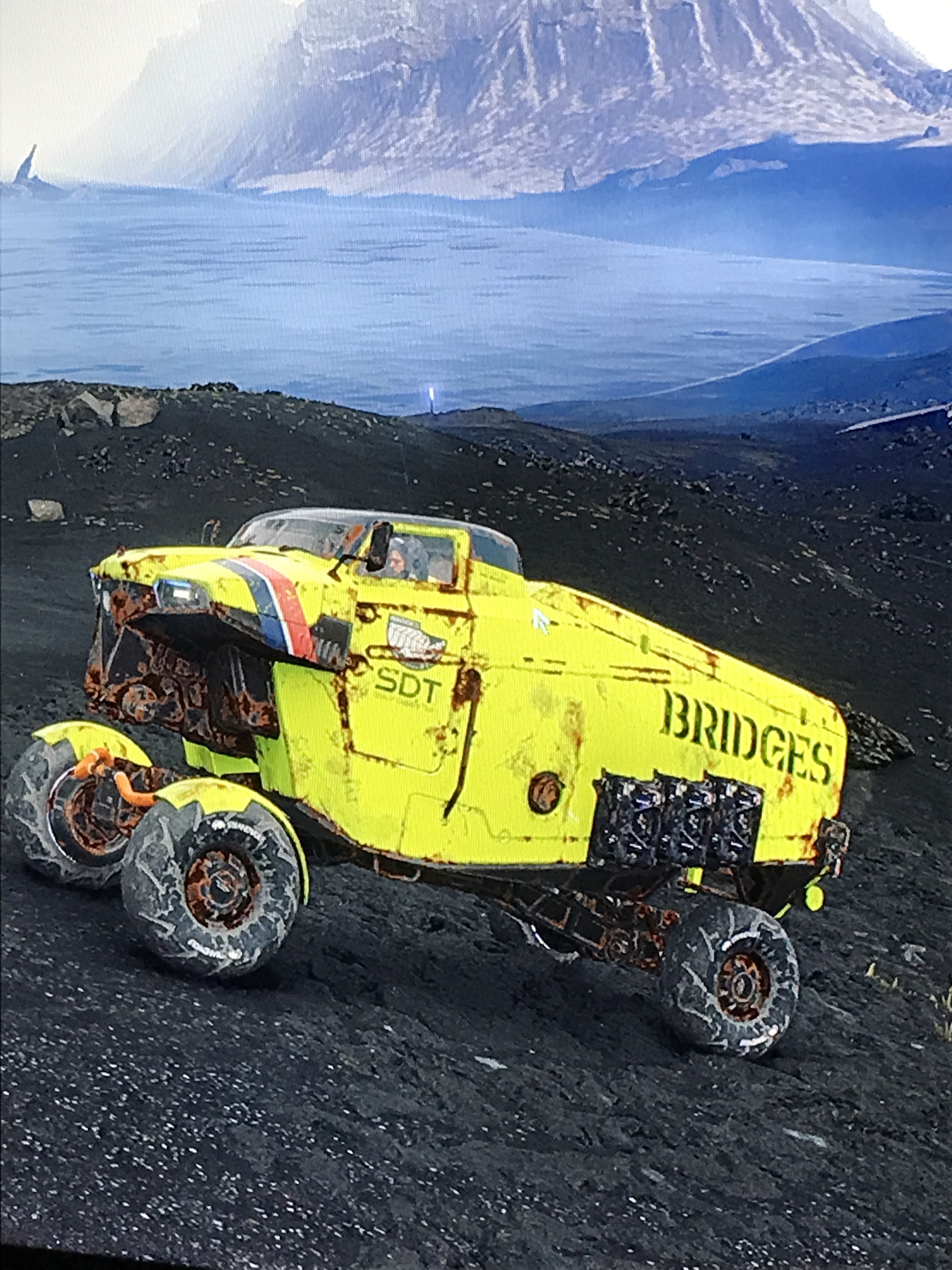 A bright yellow long range truck from Death Stranding